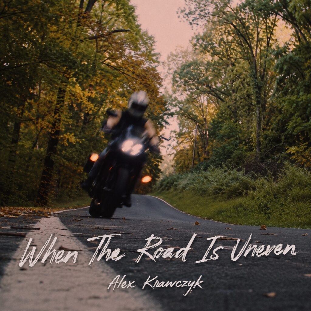 A motorcycle on an uneven road in the forest.